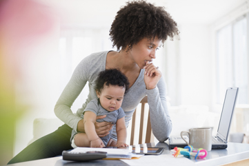 Young mom with baby working from home