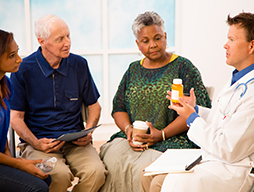 doctor talking about medications with a group of older people